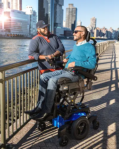 A man using power seat elevate on his wheelchair