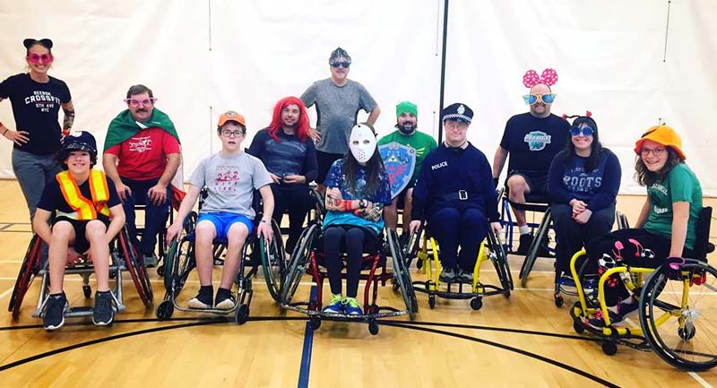 Costumed wheelchair basketball players