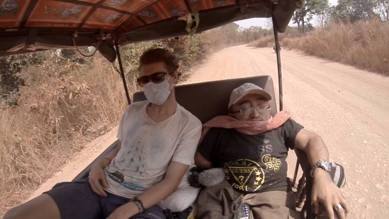 Mitch St.Pierre riding in the back of the tuk tuk in Cambodia