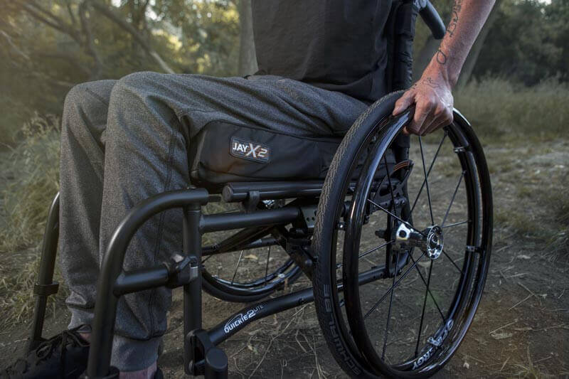 A man using a JAY X2 wheelchair cushion